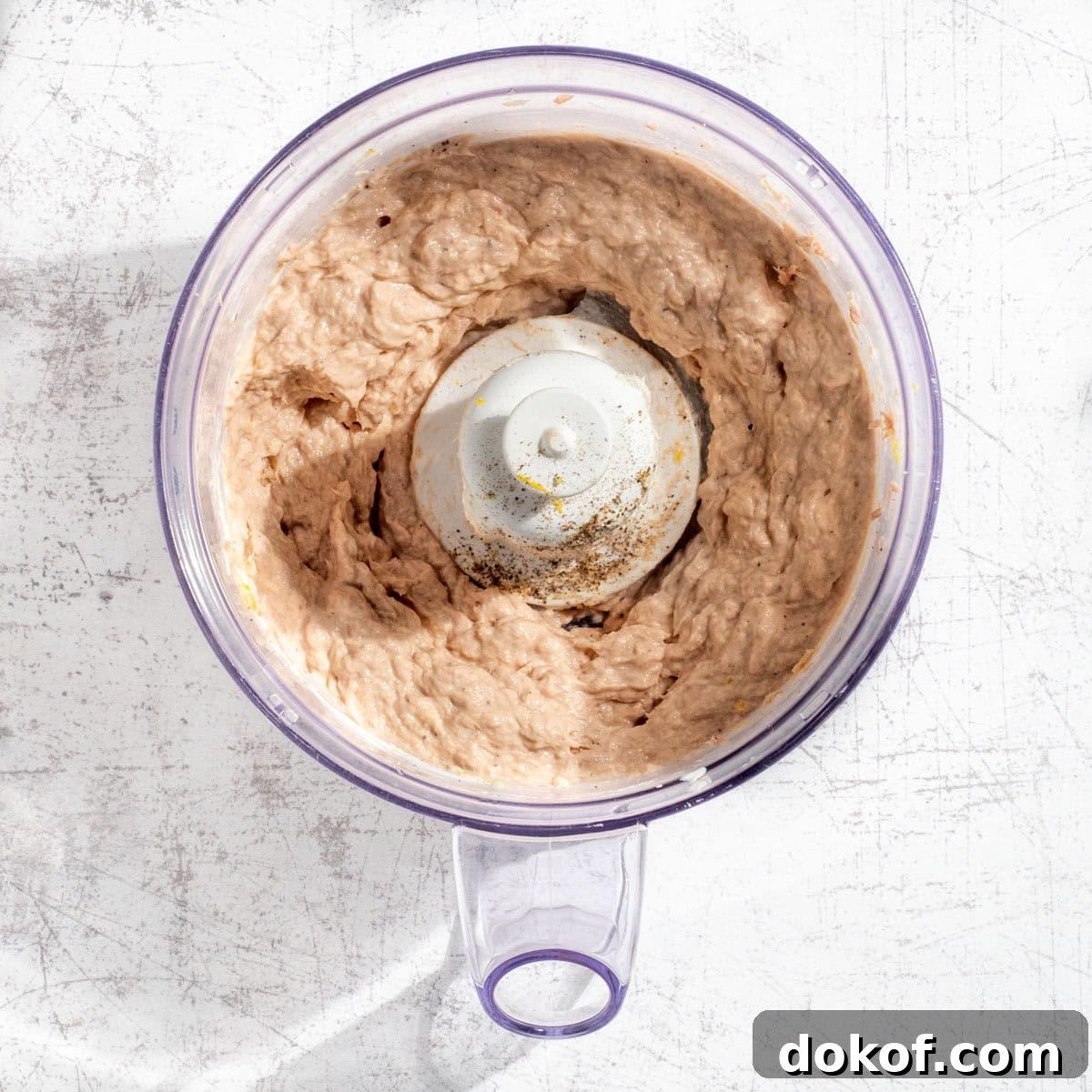 Blended tuna pate in the bowl of a food processor.