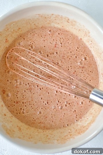 Whisking together the sugar and eggs for ruby chocolate brownies.