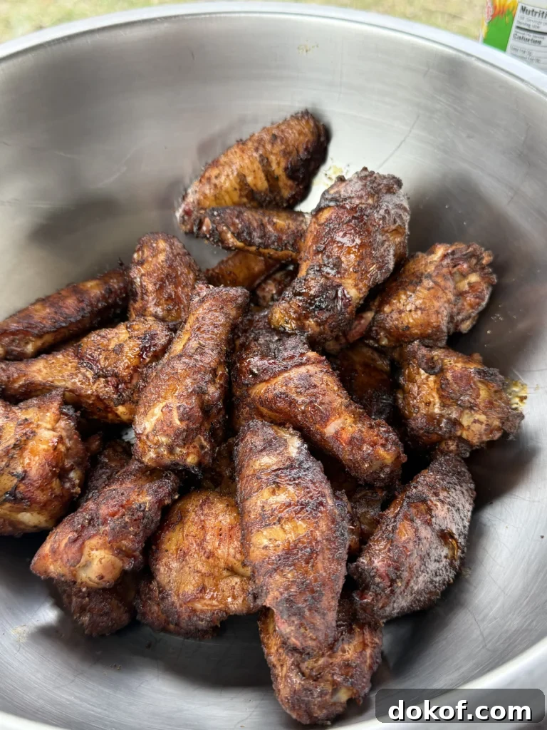 chicken wings in a bowl ready to be tossed