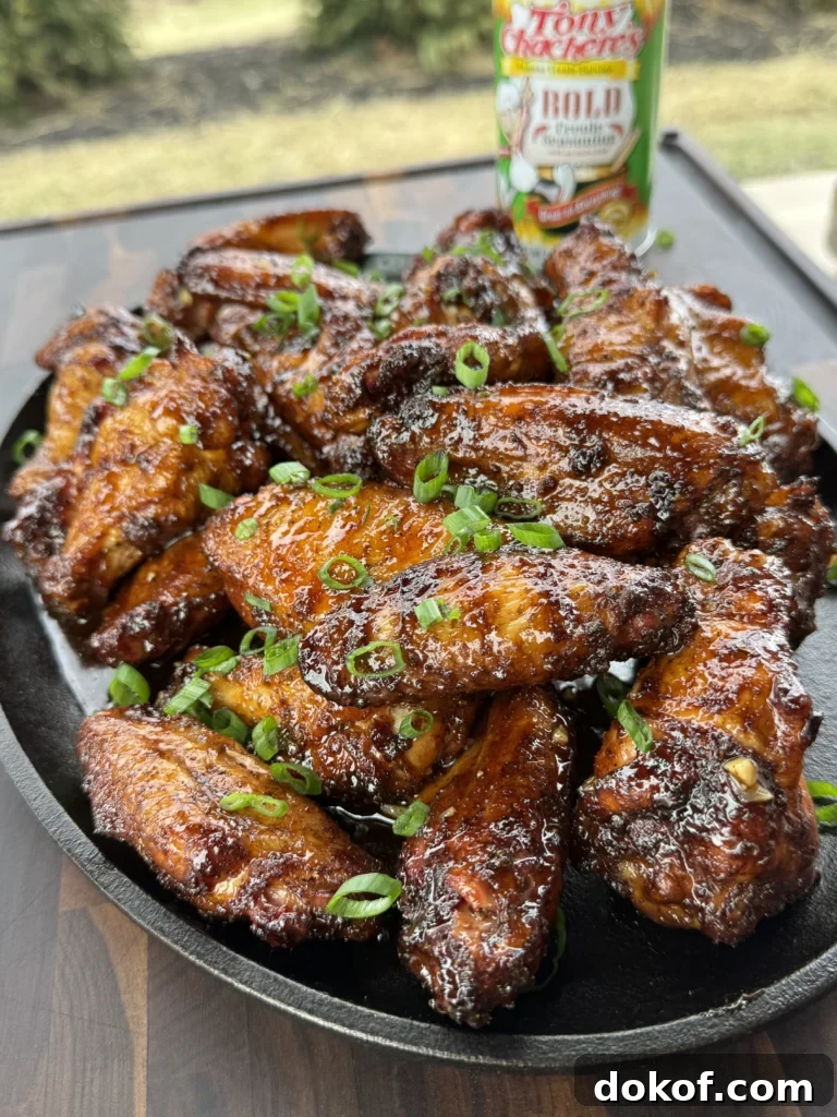 Served smoked hot honey chicken wings with a bottle of Tony's in the back