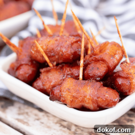 a plate of bacon-wrapped sausages.