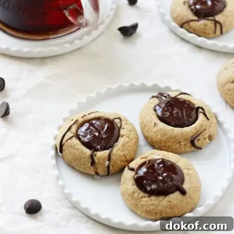 Irresistible chocolate peanut butter thumbprint cookies! With a soft peanut butter base, a chocolate peanut butter filling and a touch of flaky sea salt! Gluten-free & vegan!