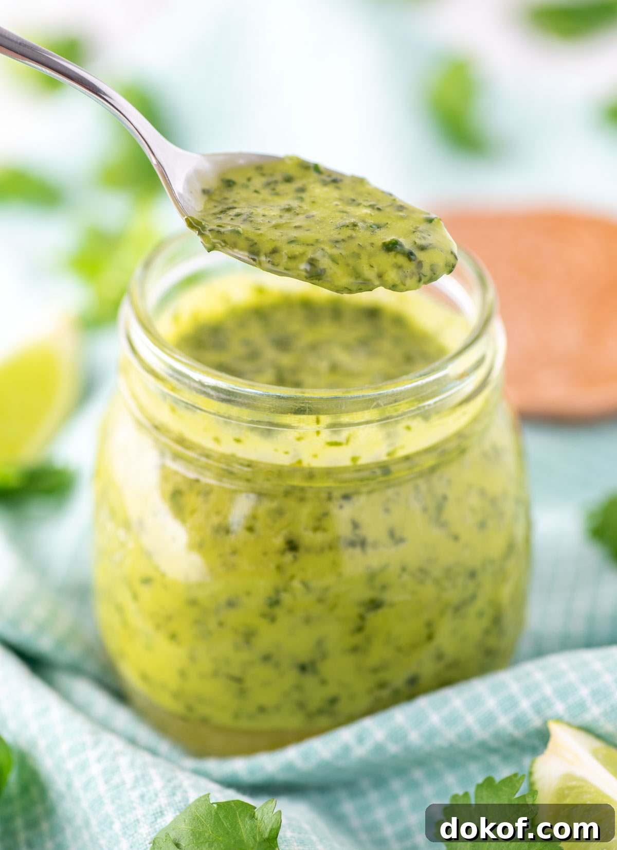 spooning out cilantro lime vinaigrette from jar
