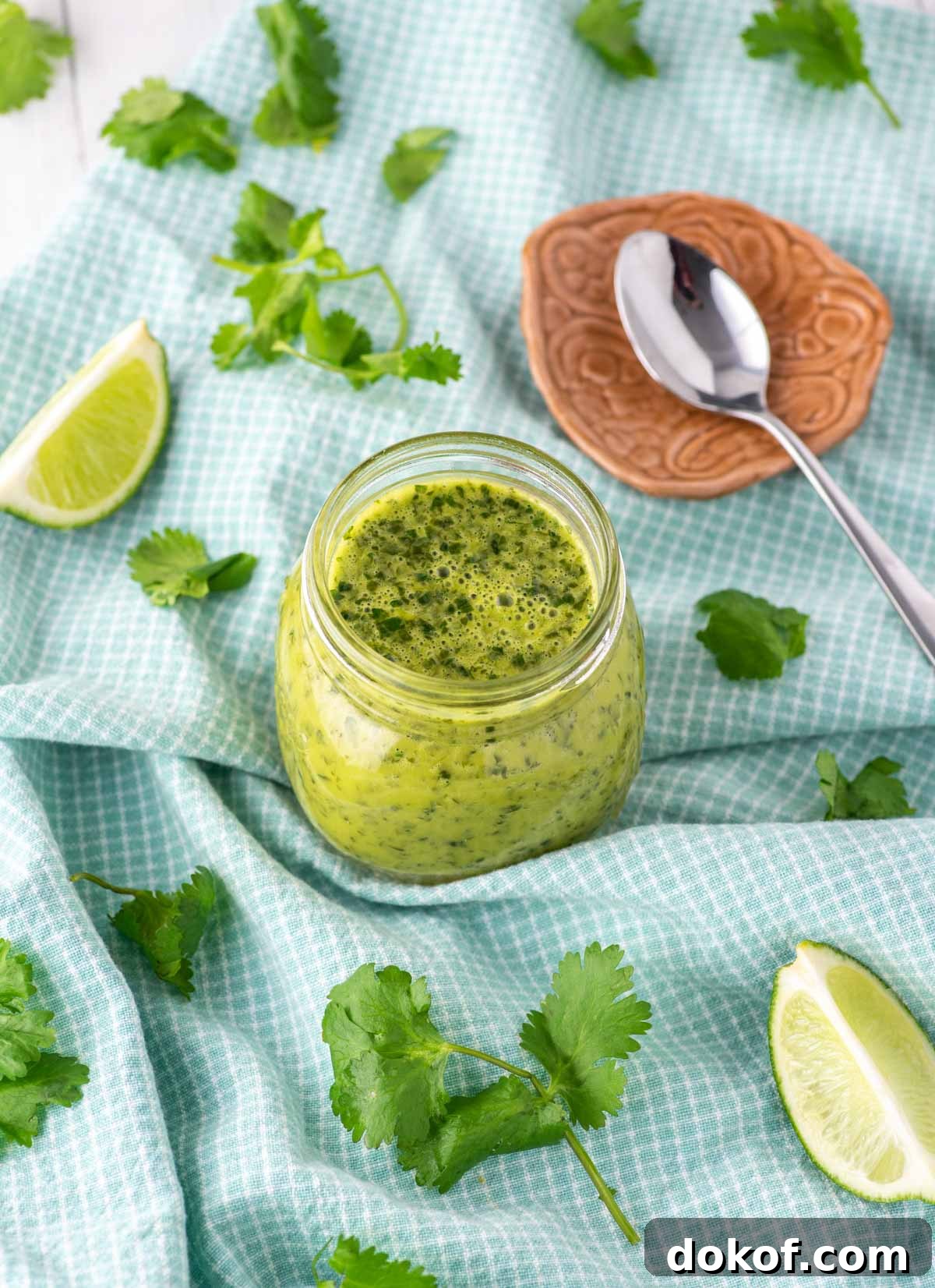 cilantro lime vinaigrette in glass jar on dish towel