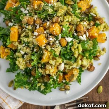 overhead shot of kale cauliflower salad on white plate with fork