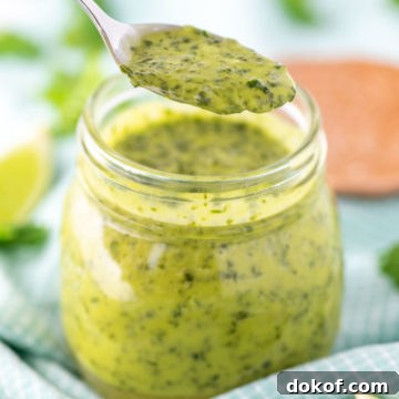 spooning out cilantro lime vinaigrette from jar