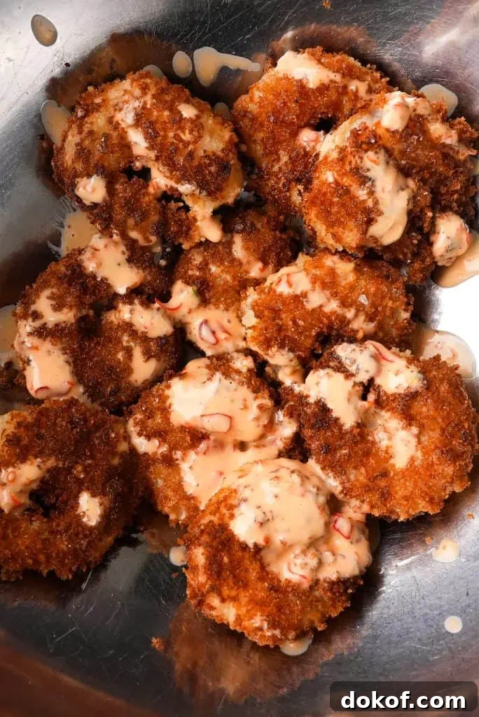 what to serve with bang bang shrimp Crispy fried shrimp are tossed in bang bang sauce inside a metal mixing bowl, with sauce lightly pooling around the shrimp.