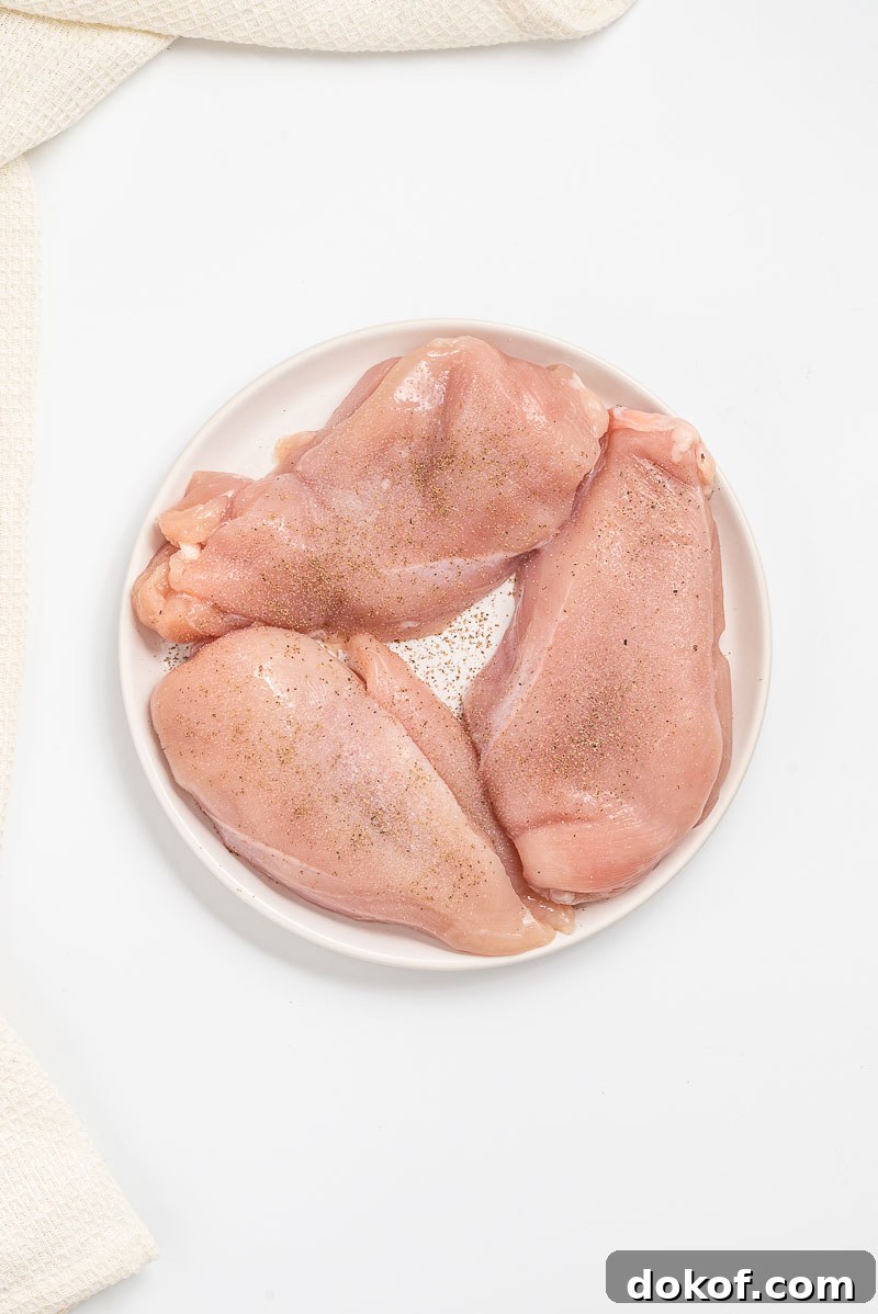 Seasoning the chicken.