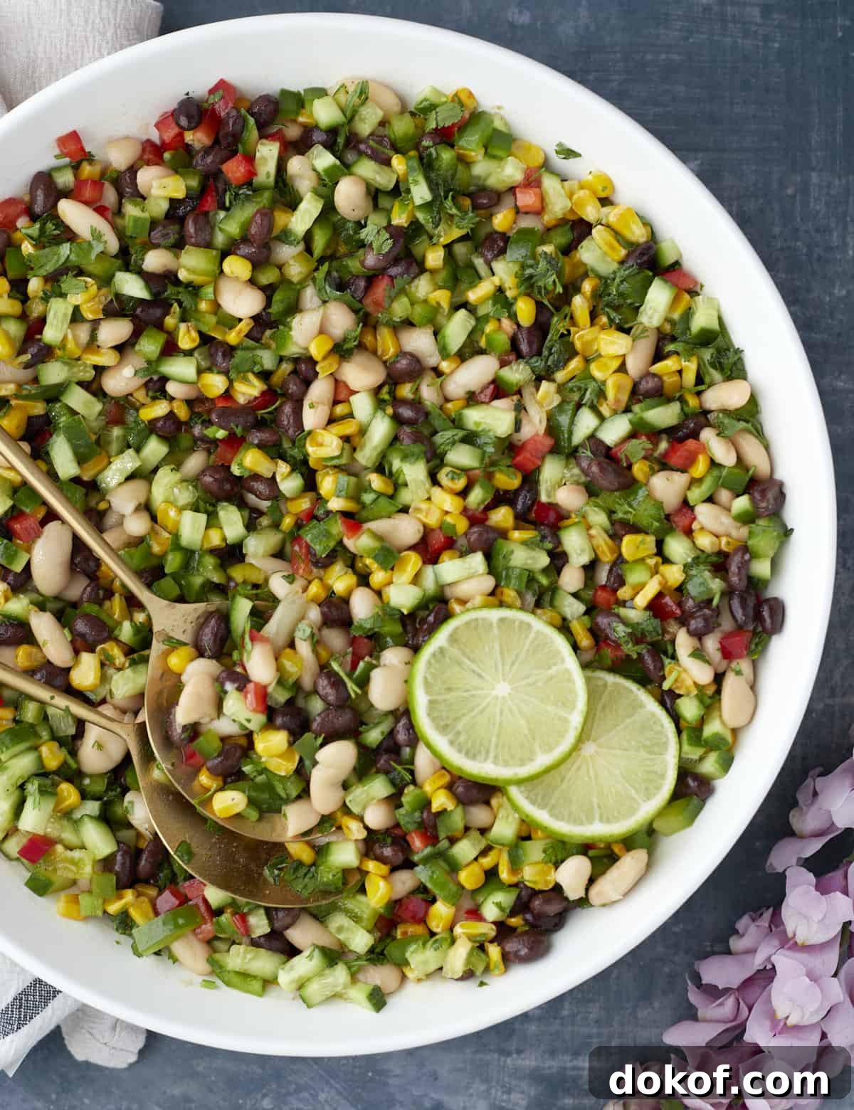 large white bowl with cowboy caviar, limes, and gold spring spoons