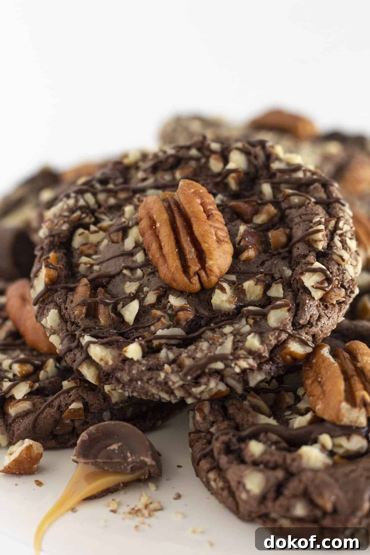 Chocolate Cake Mix Cookies: 12 Irresistible Recipes You’ll Love 7 Turtle Cookies on a white cake plate with pecans and caramel.