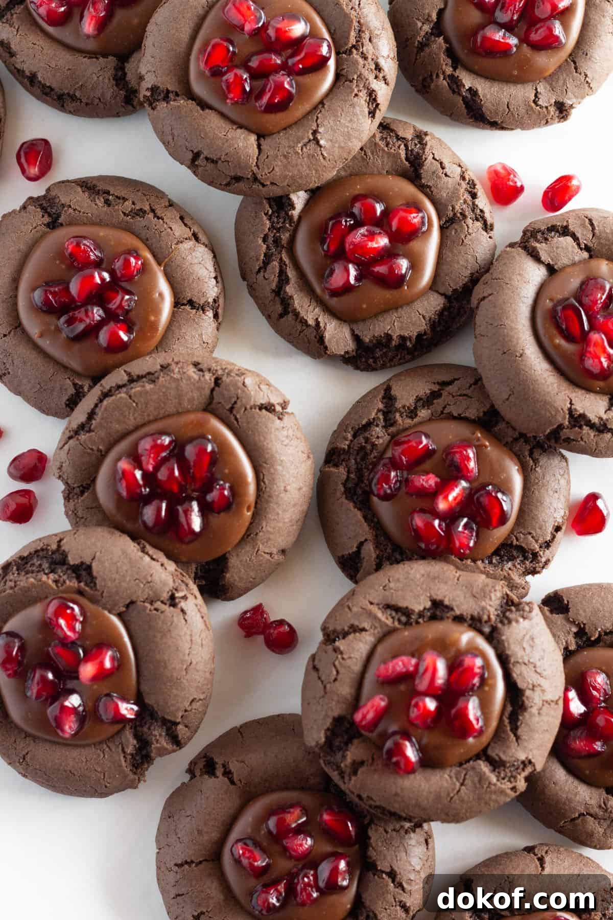 Chocolate Cake Mix Cookies: 12 Irresistible Recipes You’ll Love 9 Chocolate pomegranate cookies on a tray with fresh pomegranate seeds.