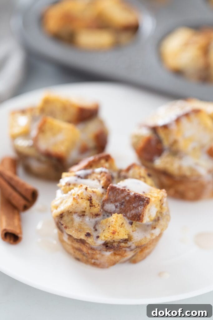 Cinnamon Roll French Toast Casserole Cups Recipe 3 A close up shot of three french toast casserole muffins
