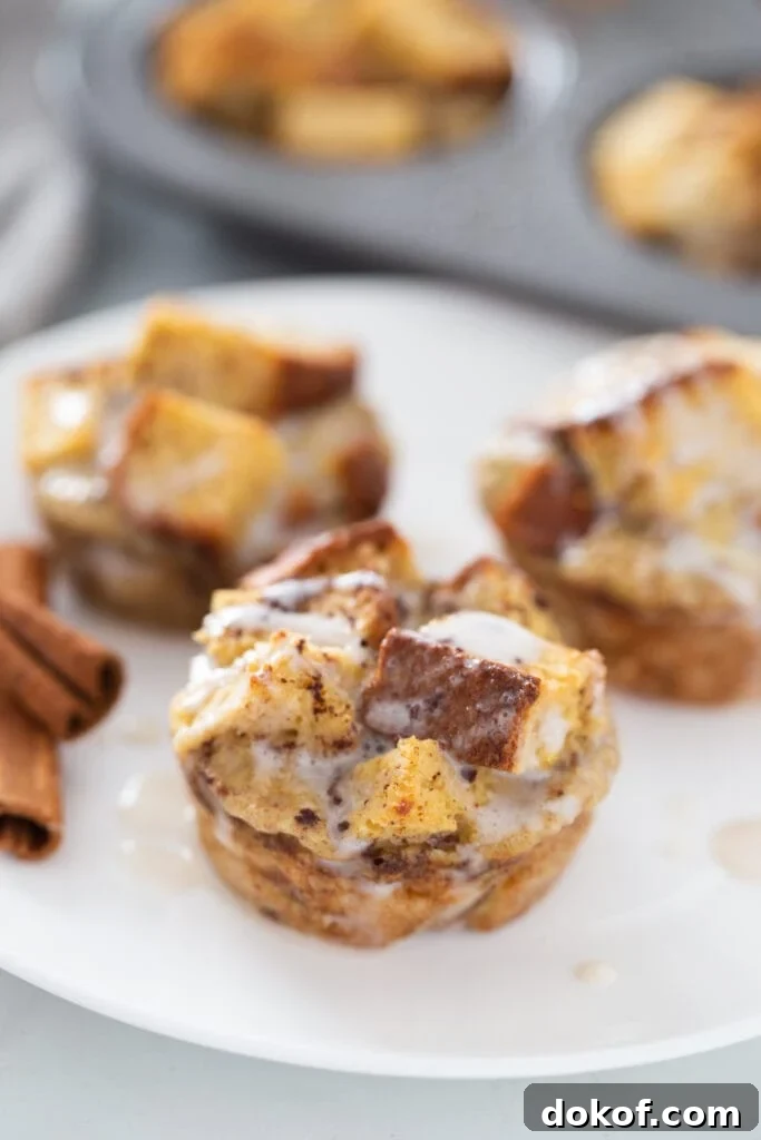 Cinnamon Roll French Toast Casserole Cups Recipe 4 Cinnamon sticks are on a white plate of cinnamon French toast caasserole cups