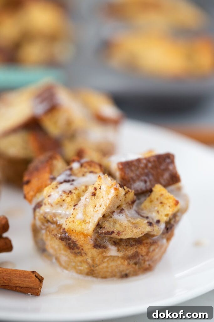 Cinnamon Roll French Toast Casserole Cups Recipe 8 A close up shot shows the icing drizzled on the French toast muffin.