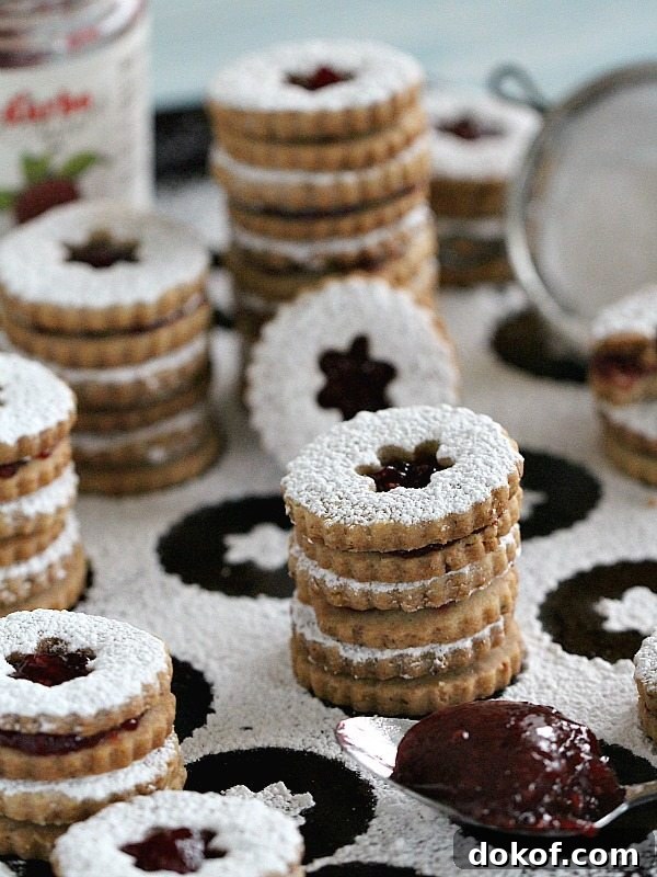 Walnut Raspberry Linzer Cookies are tender, buttery and sweet. They melt in your mouth and have a light nutty flavor and a delicious raspberry preserves middle.