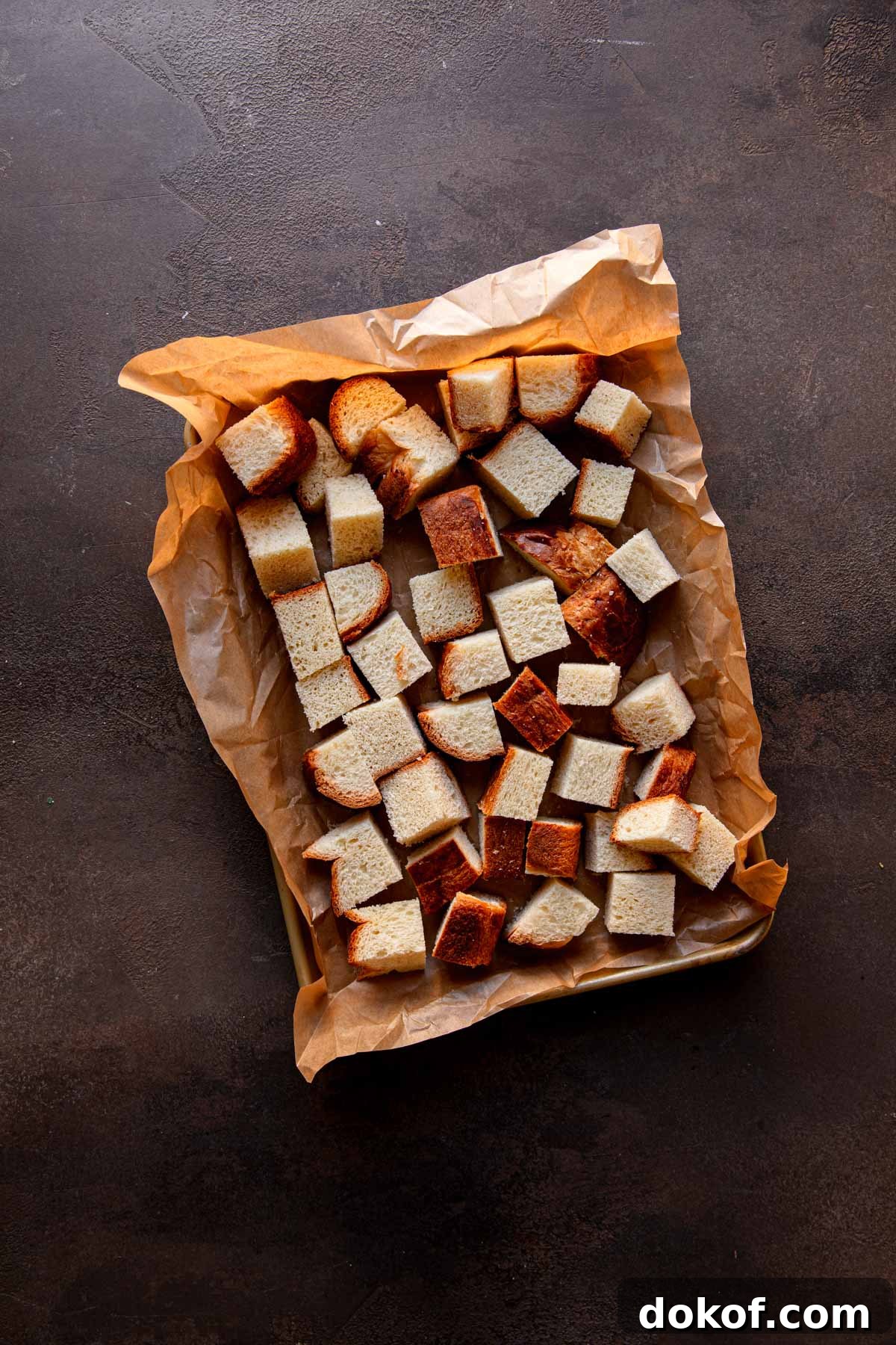 Cube bread in a baking dish.