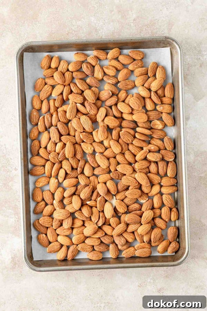 Homemade Almond Butter: Simple Recipe for Smooth, Creamy Spread 4 Almonds on a baking tray to be roasted.