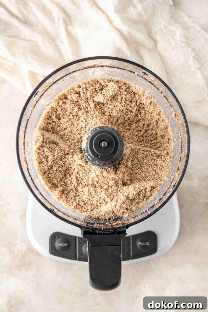 Homemade Almond Butter: Simple Recipe for Smooth, Creamy Spread 6 Breaking down the almonds into almond meal in the food processor.