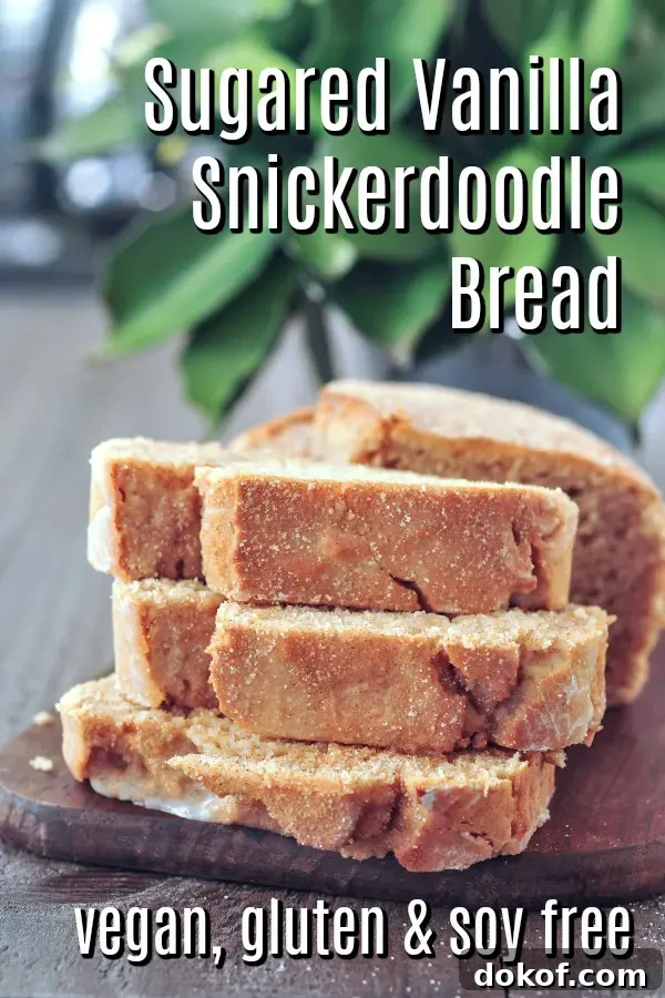 three stacked slices of snickerdoodle bread on a small wood cutting board, the rest of the loaf behind it on board.