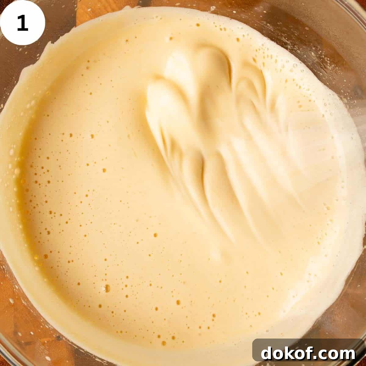 Decadent Chocolate Tiramisu Recipe for Coffee Lovers 4 Thick, creamy, yellow mixture being whisked.