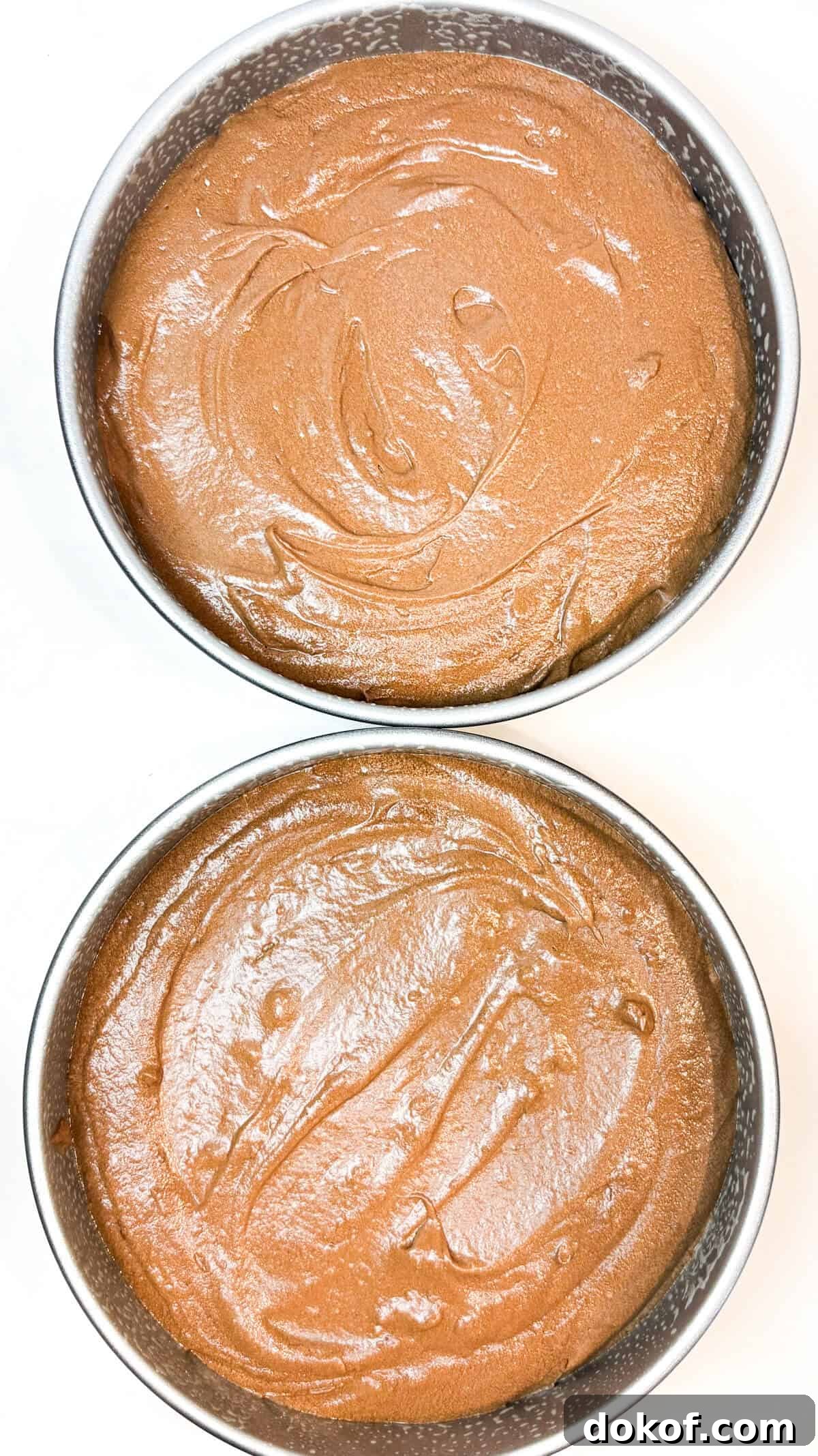 Cake batter poured equally into two pans.