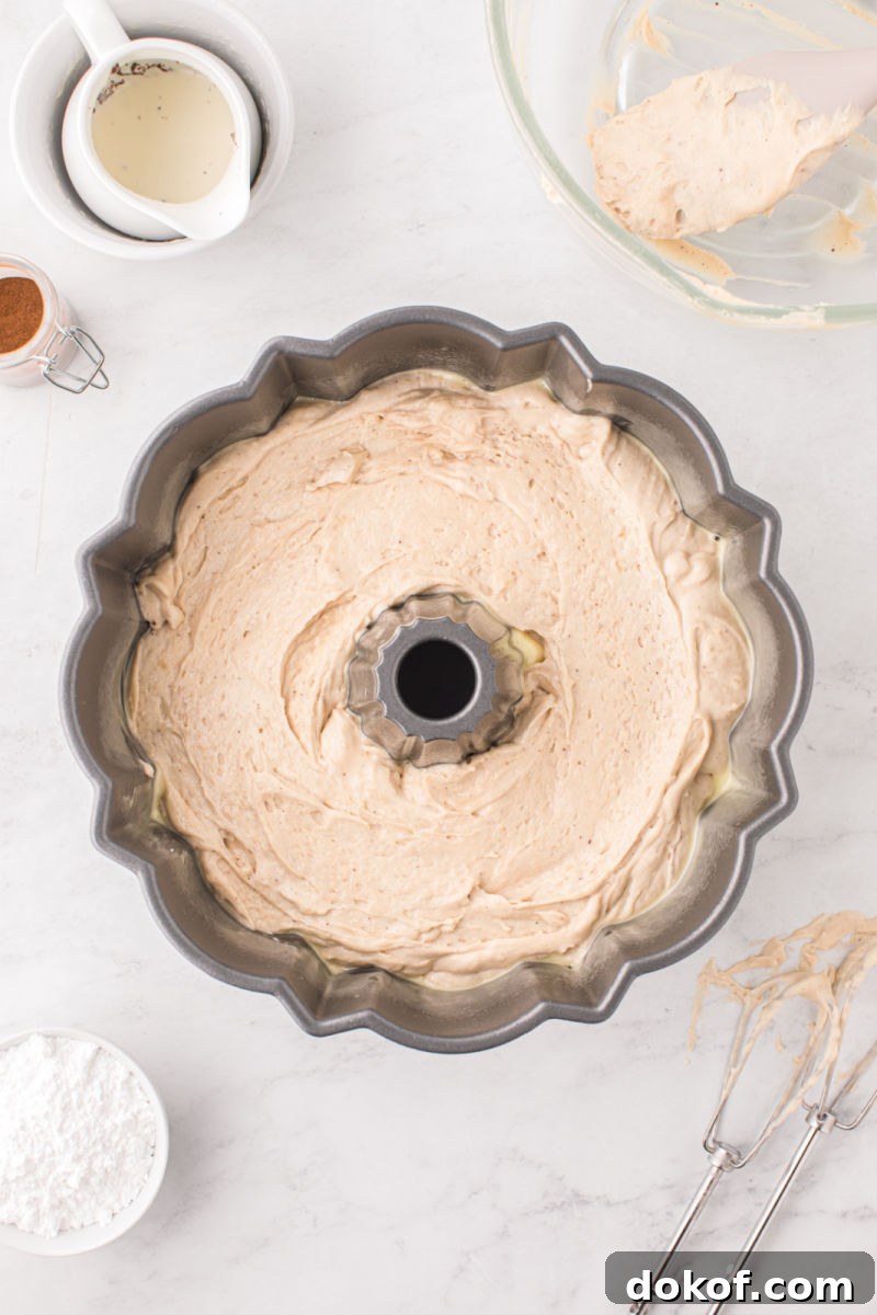 eggnog cake batter in a greased bundt pan