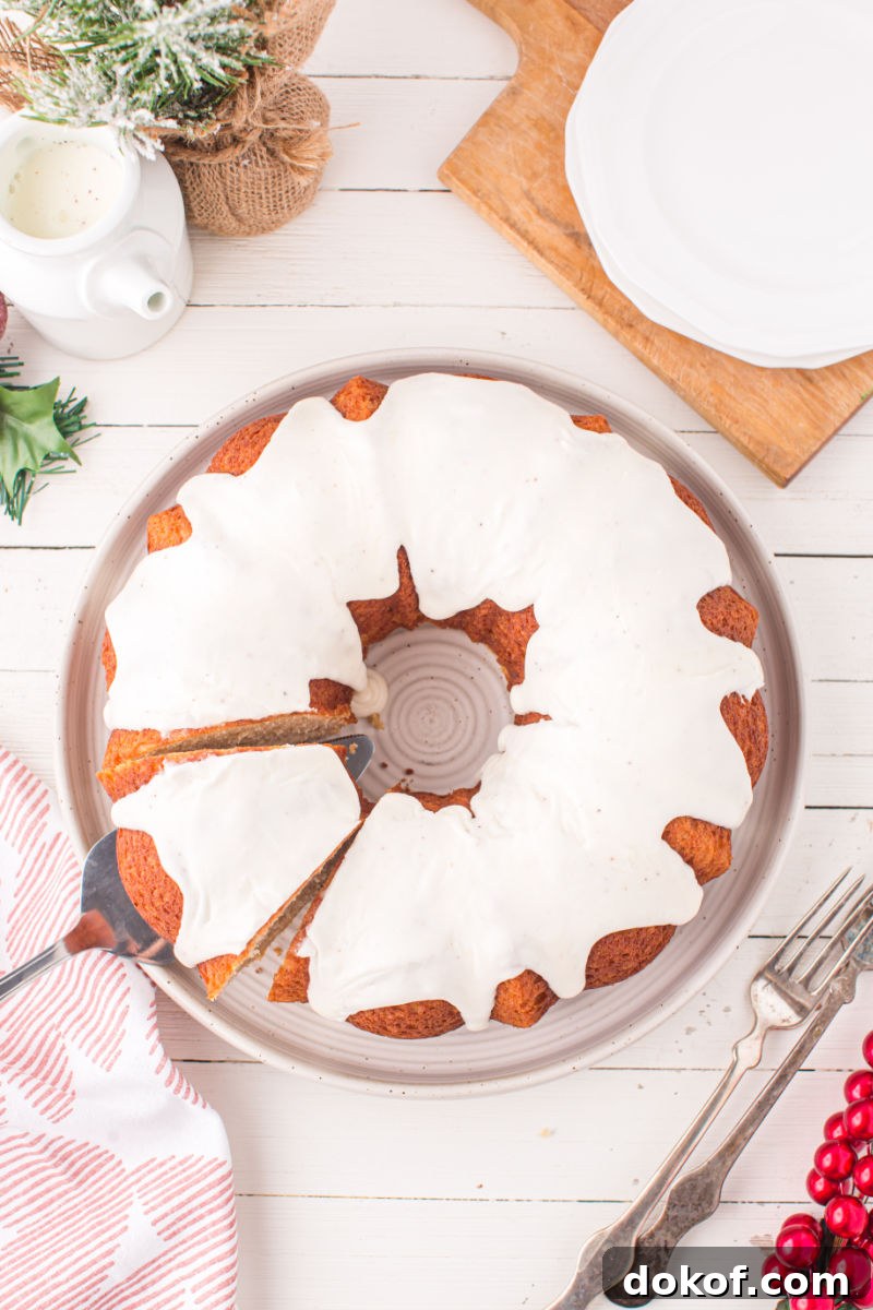 looking down at a slice of eggnog bundt cake being pulled out on a cake server