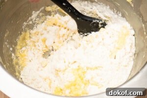 Self raising flour being added to the cupcake mixture