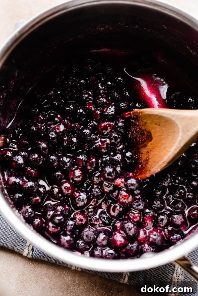 A pot of blueberry sauce cooking.