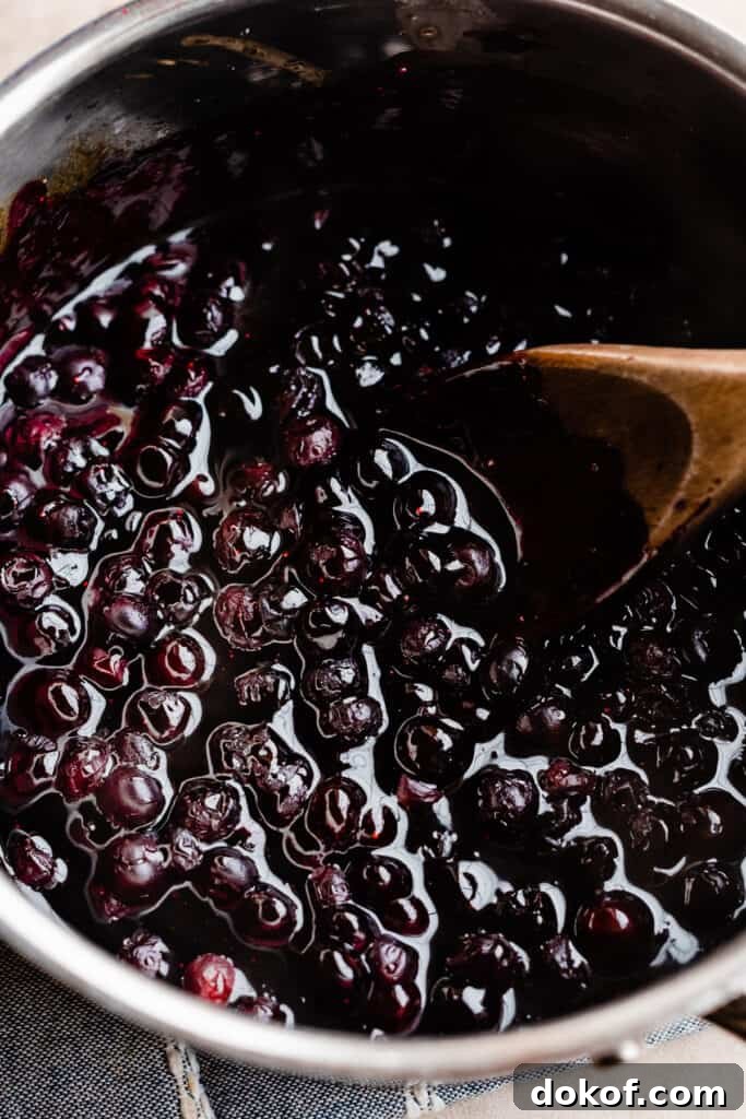 A pot of cooked blueberry sauce.