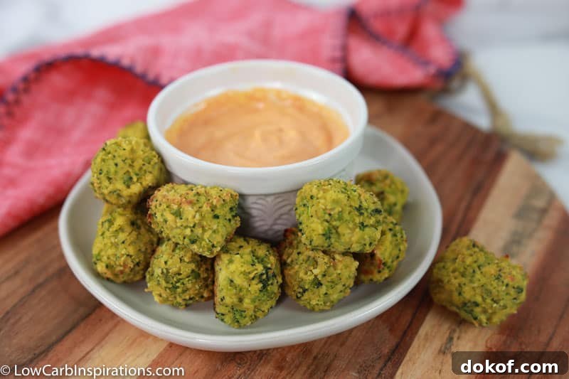 broccoli tots on a white plate with a white bowl of dipping sauce 