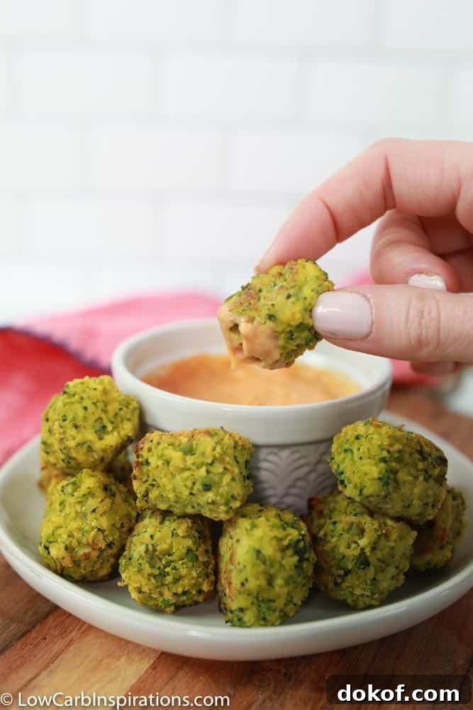 keto broccoli bites on a white plate with a white bowl of sriracha dipping sauce 