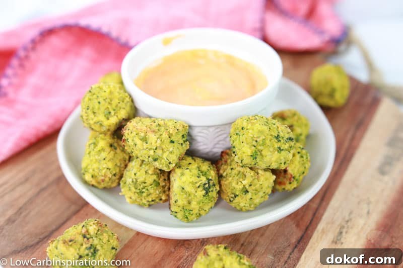 broccoli tots on a white plate with a white bowl of dipping sauce 