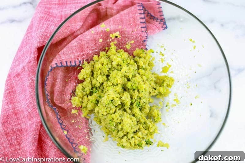 keto broccoli tots ingredients mixed together in a clear bowl 