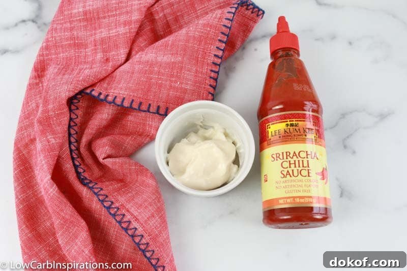 sriracha sauce ingredients in a white bowl with sriracha and a pink towel on the side 