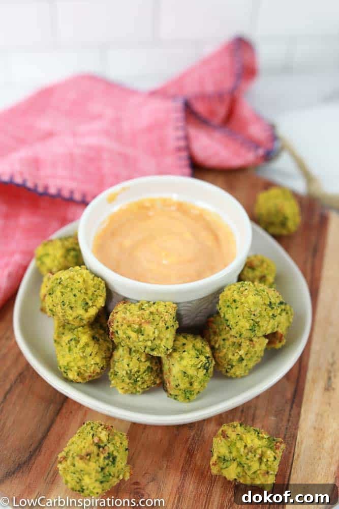 keto broccoli recipe on a white plate with a white bowl of dipping sauce 