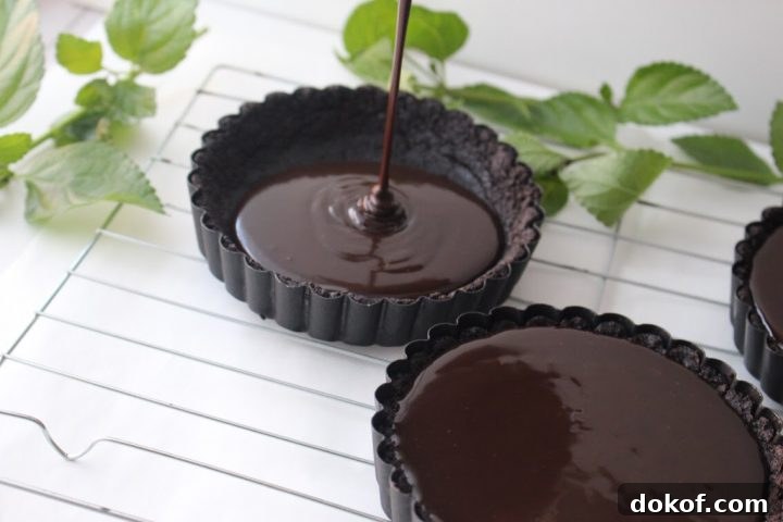 Pouring chocolate into tart shells