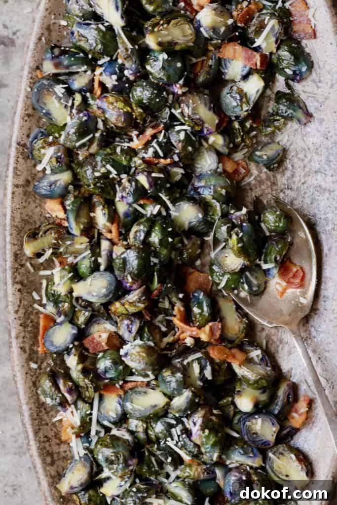 Crispy Roasted Purple Brussels Sprouts with Bacon & Parmesan 3 Close-up photo of Roasted Purple Brussels Sprouts with Bacon and Parmesan on brown platter.