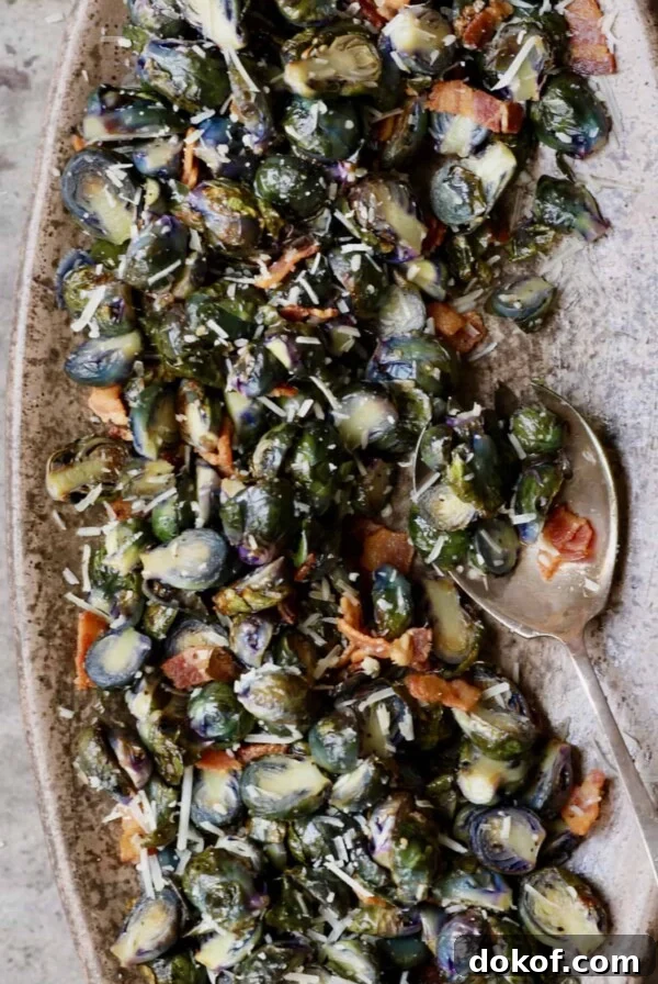 Crispy Roasted Purple Brussels Sprouts with Bacon & Parmesan 7 Roasted Purple Brussels Sprouts with Bacon and Parmesan - Overhead hero shot on brown platter