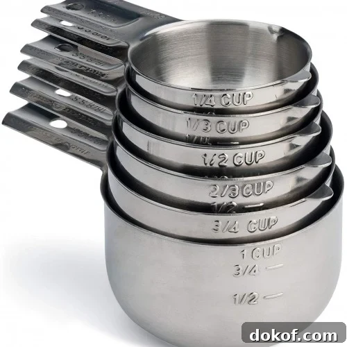 A nested stack of stainless steel measuring cups.