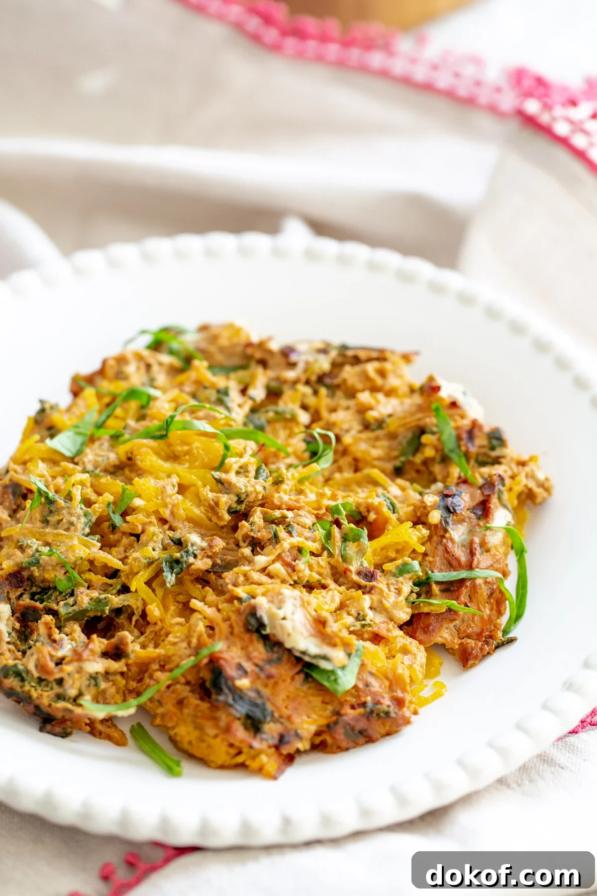 side view of a plate with vegan spaghetti squash bake with creamy tomato sauce