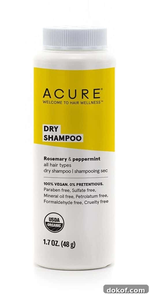 A bottle of Acure dry shampoo with a yellow label.