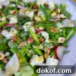 close up of asparagus salad on white plate
