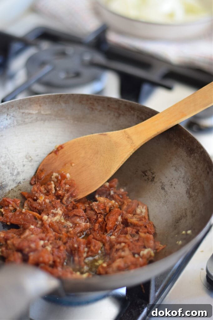 Cooking sun dried tomatoes in a wok.