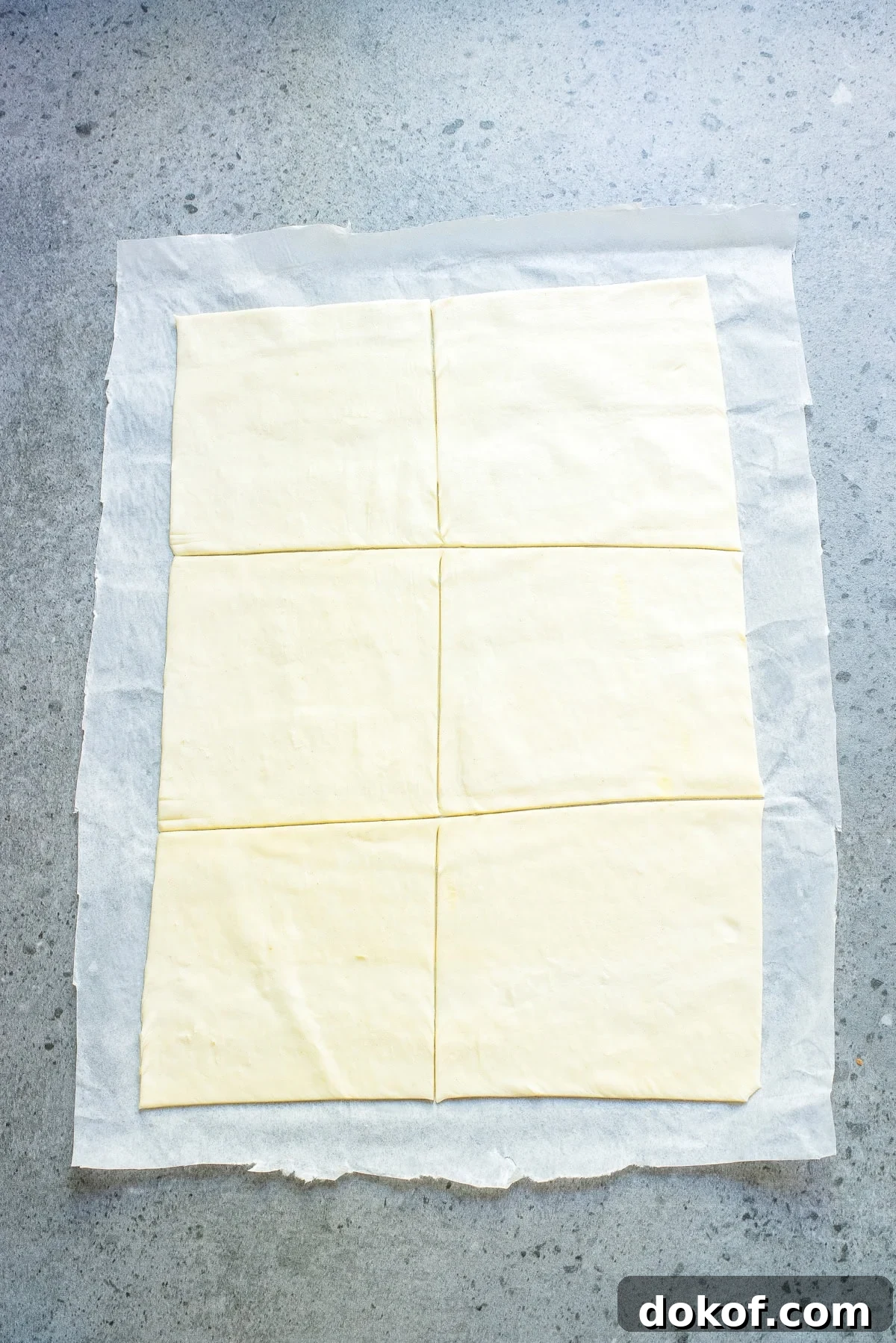 Flaky Peach Puff Pastry Tart Recipe for Summer Dessert 6 An overhead image of puff pastry sheets on a parchment paper.