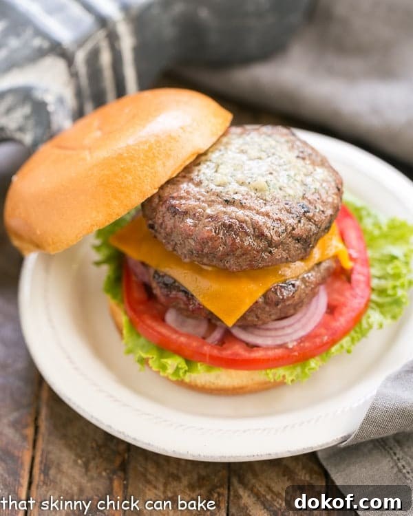 Grilled Butter Burger  on a white plate with the top bun leaning on the loaded burger.