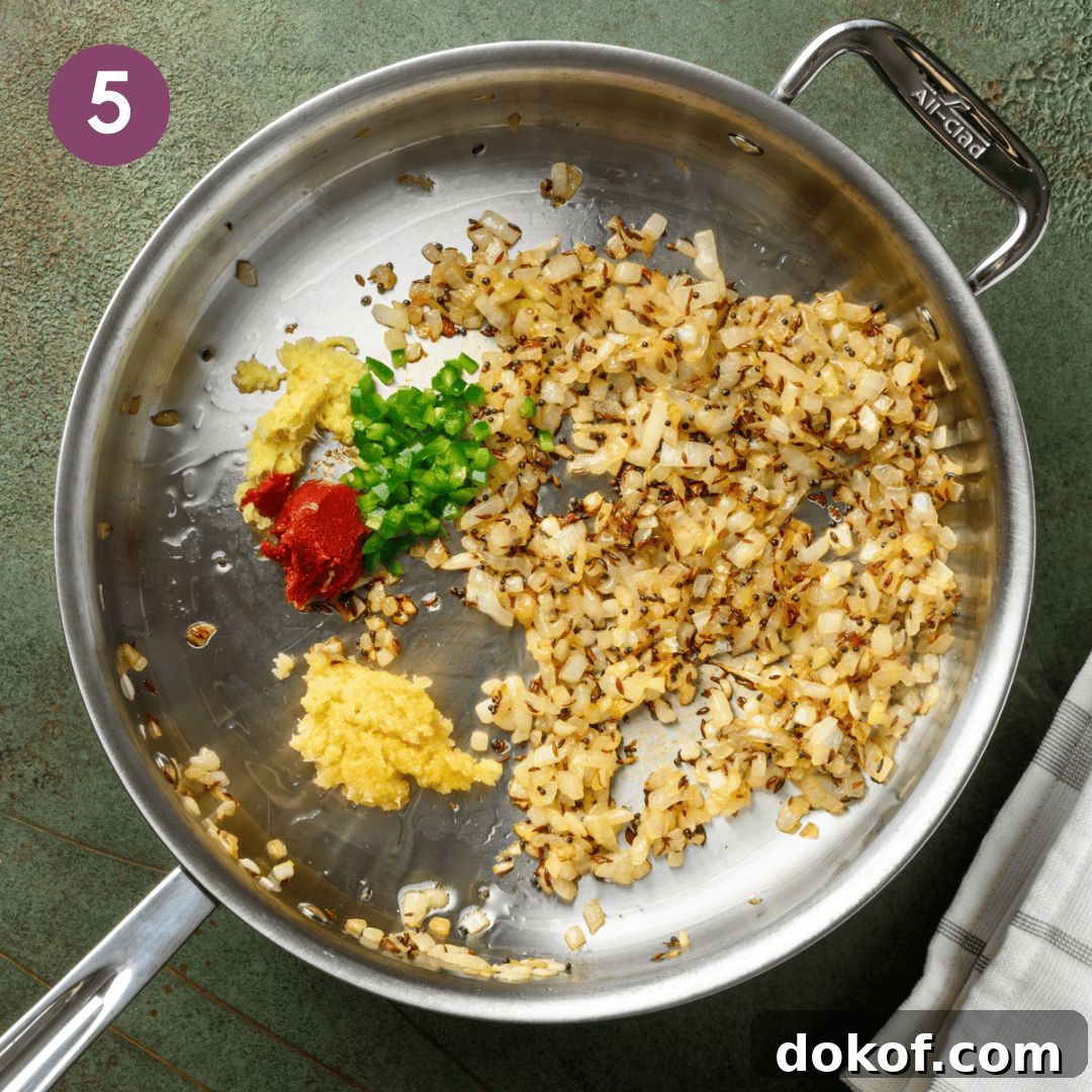 garlic, ginger, green chile and tomato paste added to onion mixture.
