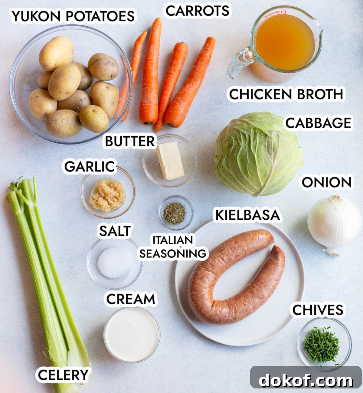 Ingredients in Creamy Kielbasa Cabbage soup with a gray background.