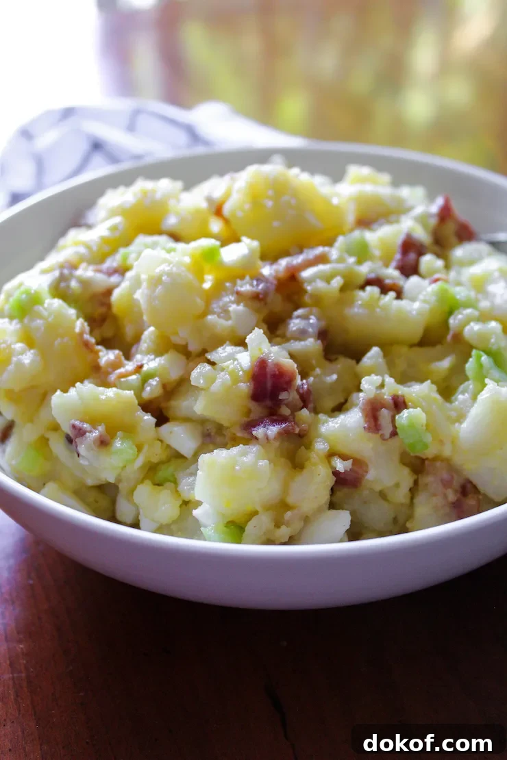 Mary’s Classic German Potato Salad Recipe 3 German potato salad in white serving bowl.