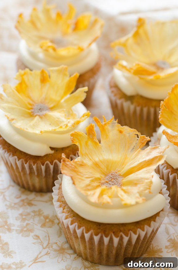 cupcakes topped with dried pineapple flowers